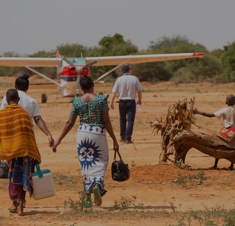 Family and pilot walking towards a MAF plane