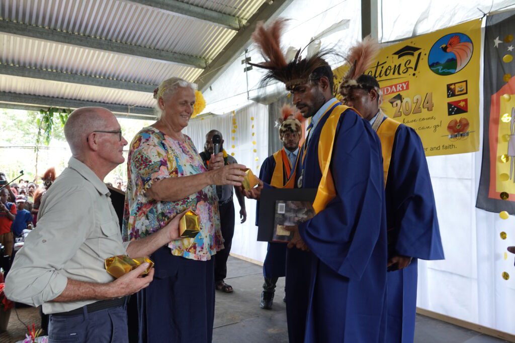 Founder Sally Lloyd & husband & school head, Ian Lloyd, award gifts to the graduates (credit: M. Glass)