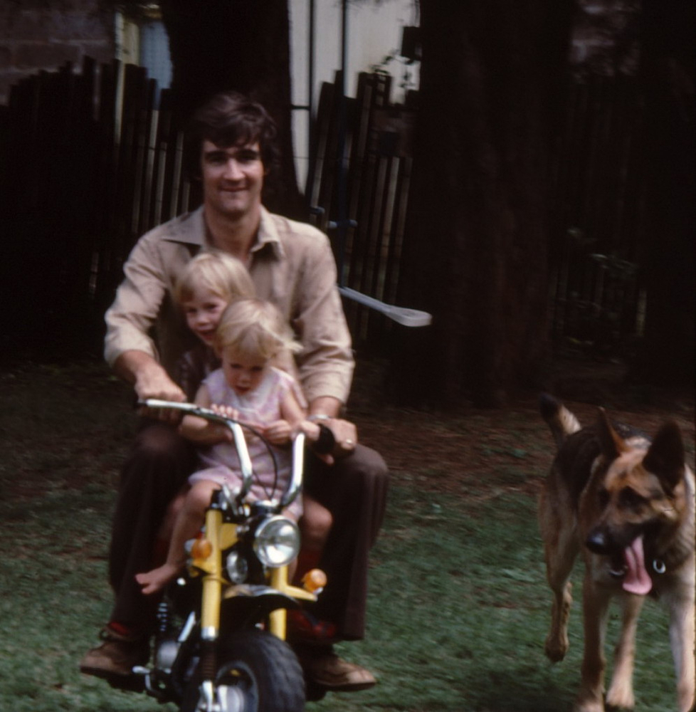 Sara (centre) and Ruth (front) on a bike with dad Max along with their dog Taffy (credit: Max Gove)
