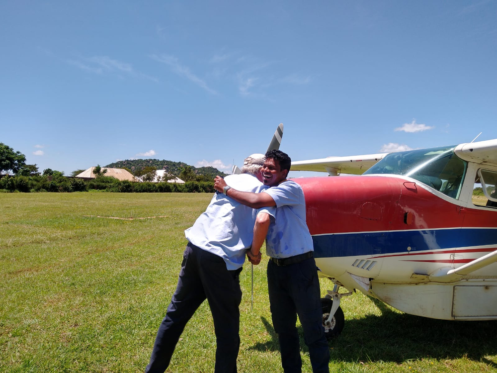Mark hugs Roshan after his 1st solo ops flight from Haydom to Gorimba in Feb 2025 (Becki Dillingham)