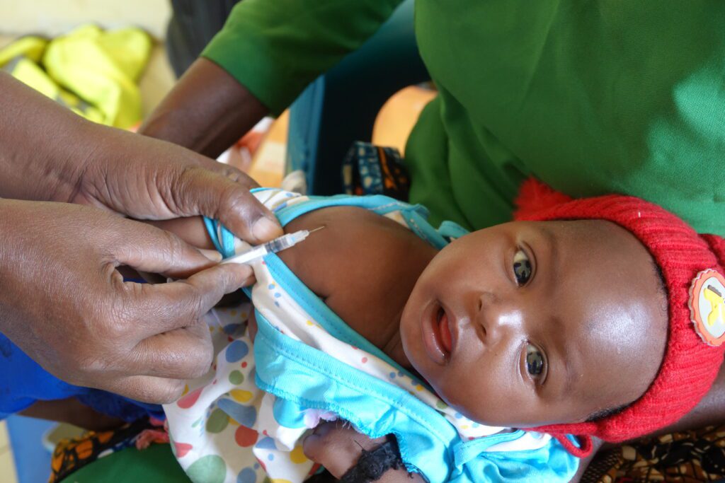 A baby receives a lifesaving vaccination in Mahaka where there are no hospitals (credit: Annet Nabbanja)