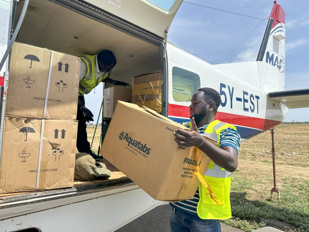 Water purification tablets are unloaded at Pibor to fight cholera (credit: Jenny Davies)