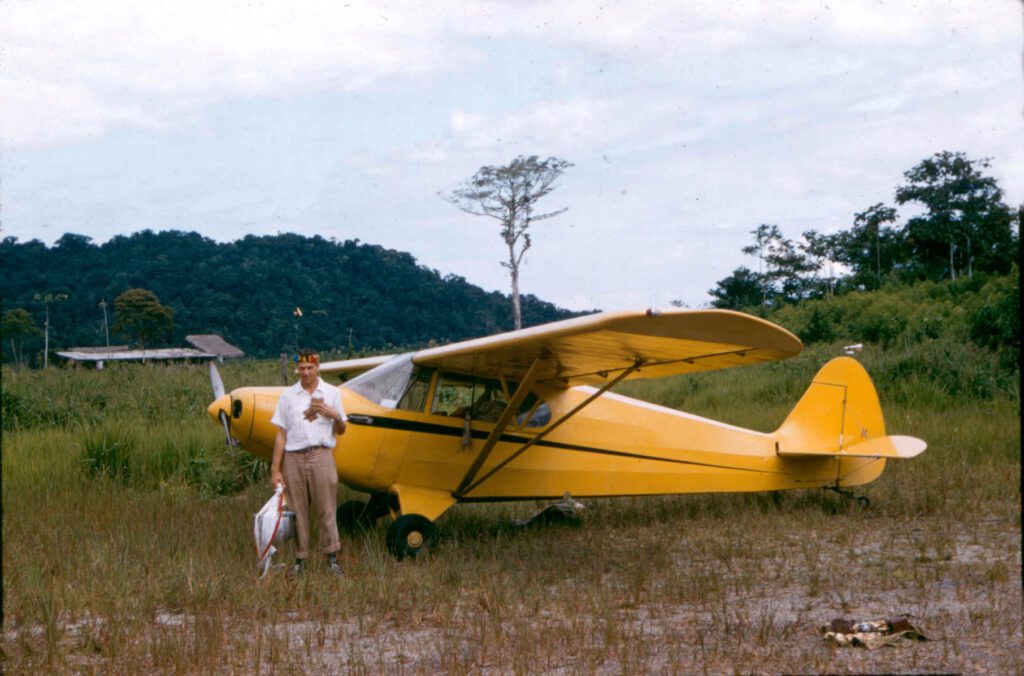 Ed McCully in front of MAF’s yellow Piper PA-14 Family Cruiser aircraft (credit: MAF US)