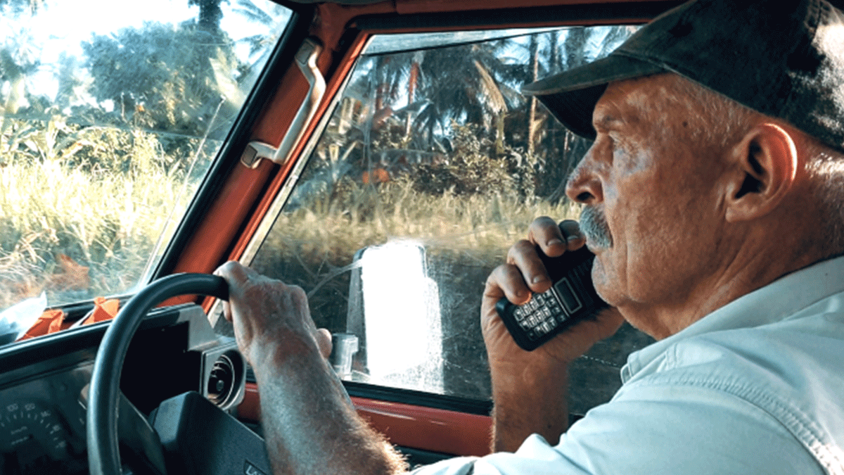 Dr Kirby using recently installed hand-held radio tech in his car