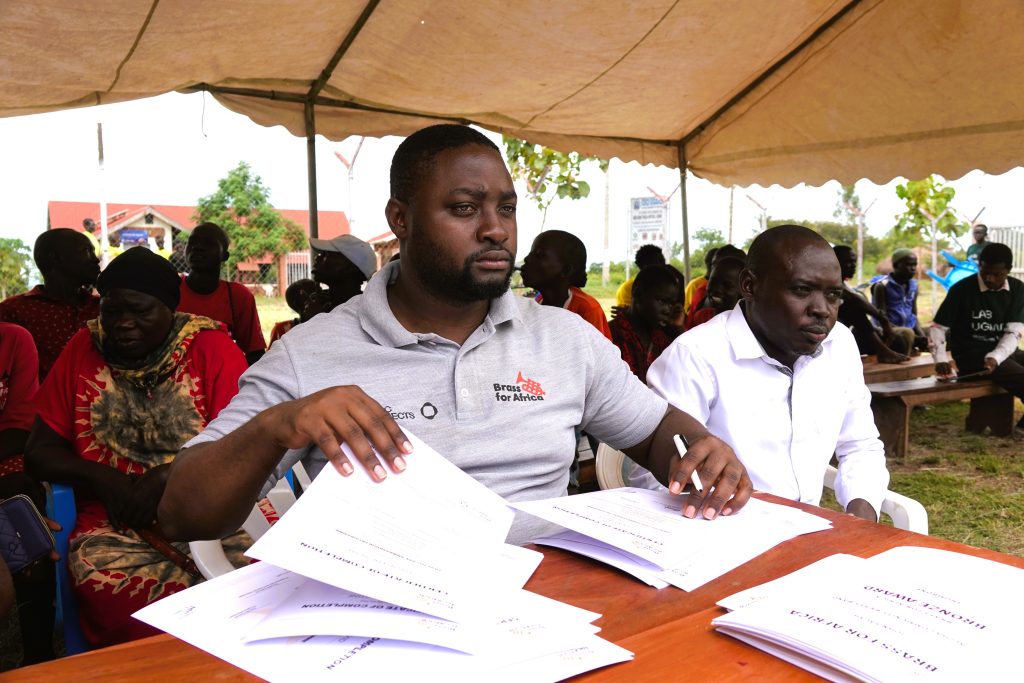 Ronald Kabuye (L) was orphaned by war. Now he’s a manager at Brass for Africa (credit: Damalie Hirwa)