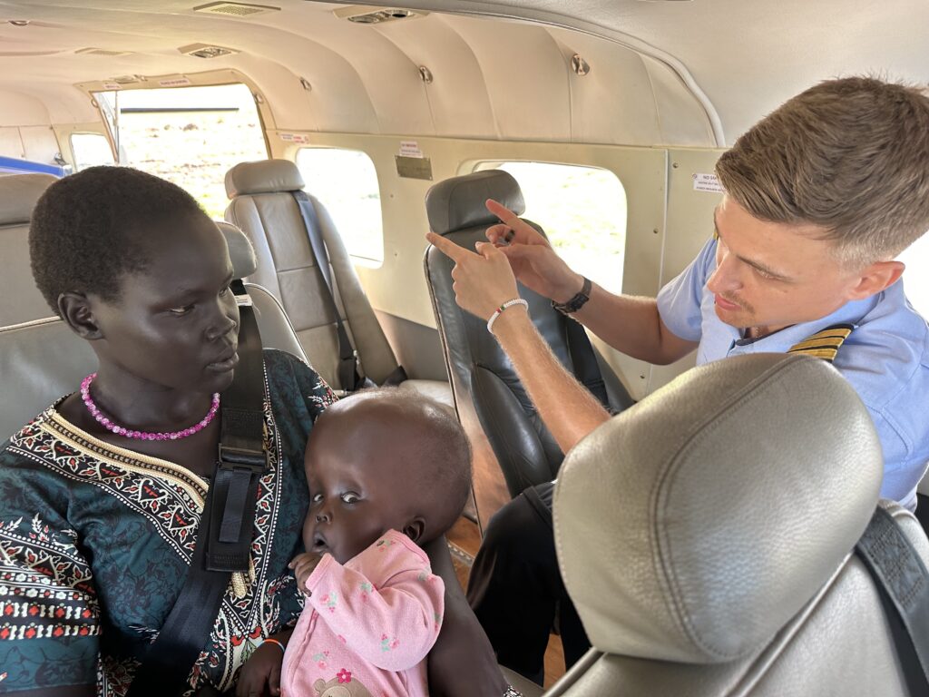 MAF flies hydrocephalus & spina bifida patients from S. Sudan to Uganda to access care (credit: Jenny Davies)