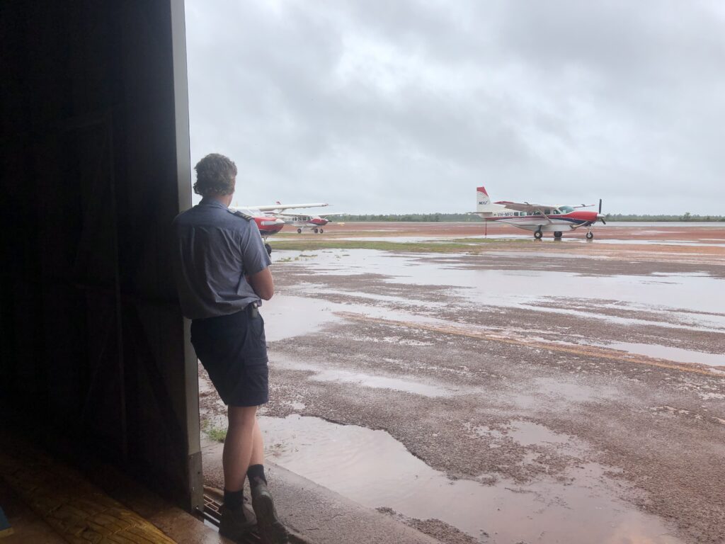 MAF pilot Ethan McMaster looks out onto a drenched Gove Airport (credit: Joshua Oliver)