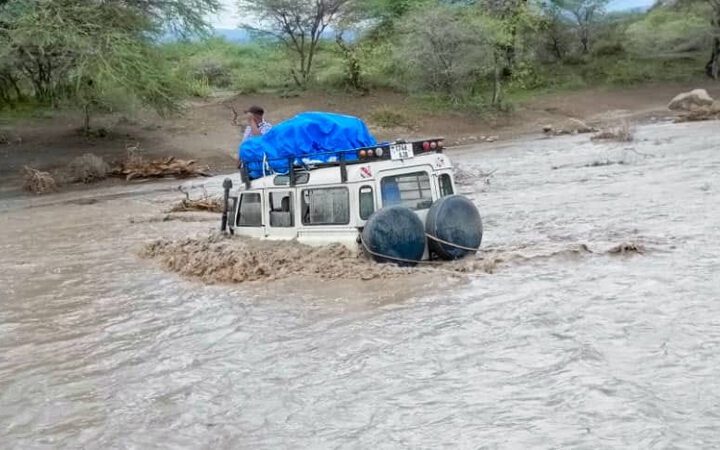 A car is partially submerged when Sanjan River bursts its banks in the Arusha Region (credit: John Mayani)